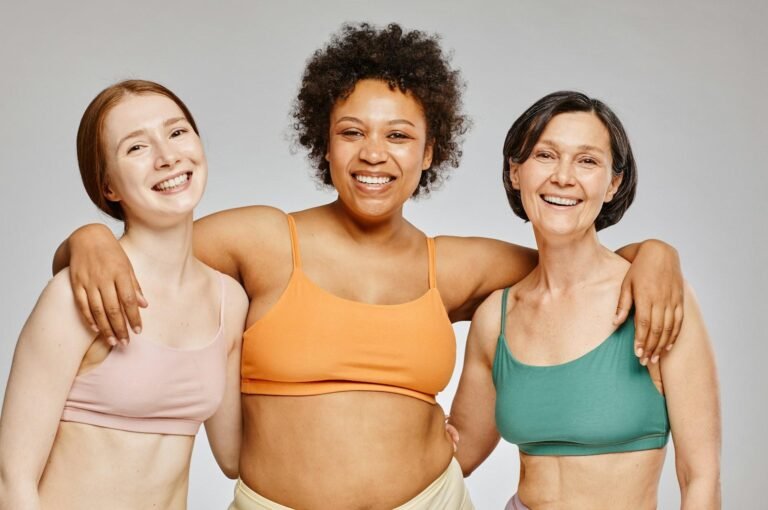 Women of different ages standing together and smiling, symbolizing midlife health, body confidence, and lifelong wellbeing