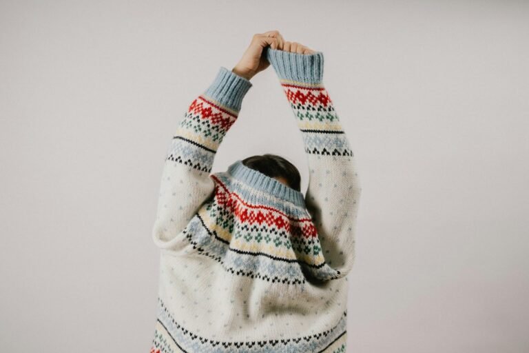 Person wearing a patterned heritage knit sweater, highlighting traditional wool craftsmanship and timeless style