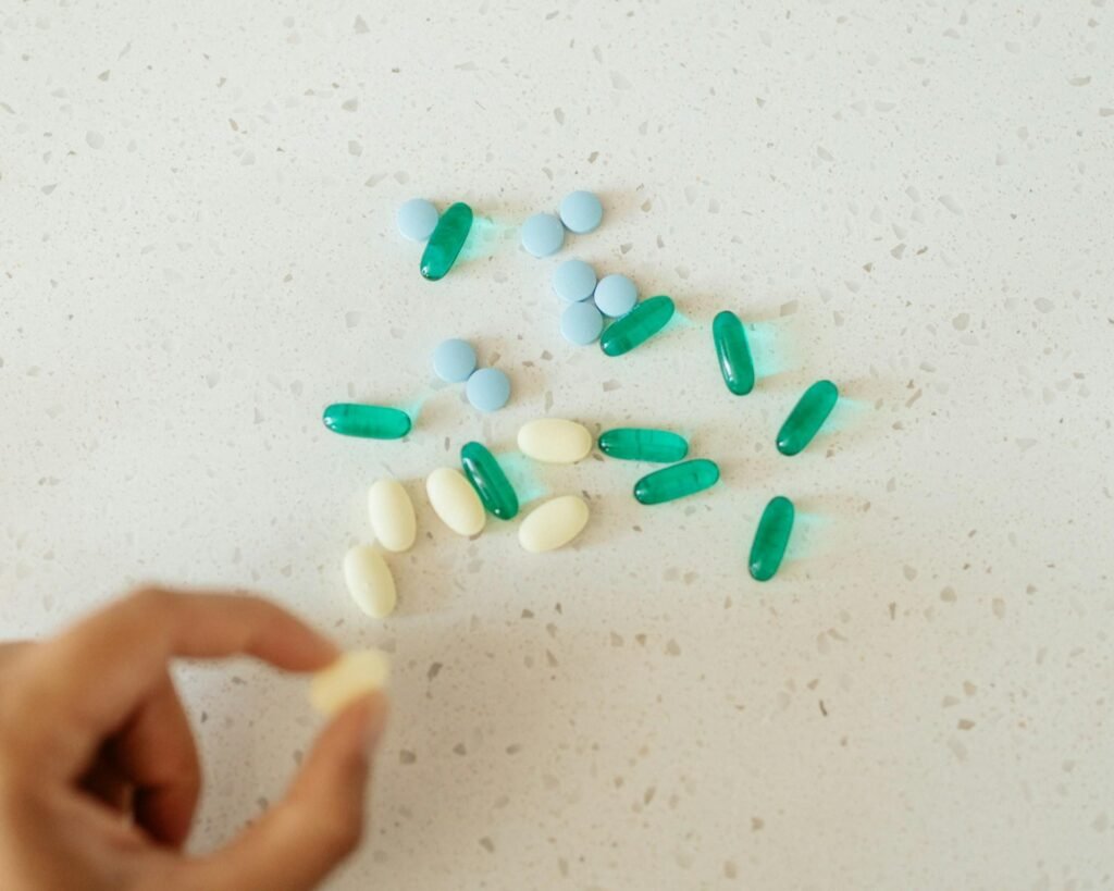 Assorted supplement tablets and capsules arranged on a surface, reflecting modern daily wellness habits