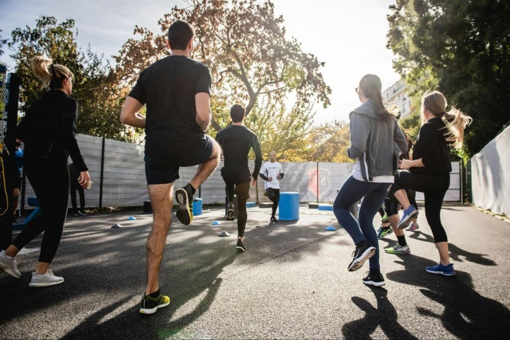 Group of people exercising outdoors, highlighting the connection between movement, coordination, and overall sensory health